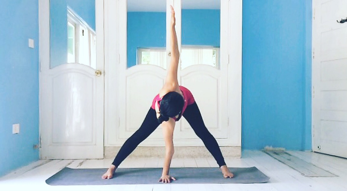 Prasarita Padottanasana Parivrtta (Revolved Wide-Legged Standing Forward Bend).